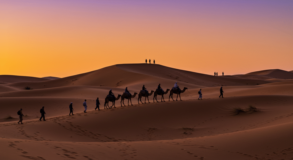 Camel caravan crossing the Sahara Desert at sunset